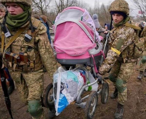 Soldiers taking baby out of ruin