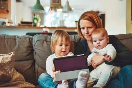Mother using a computer with her two children