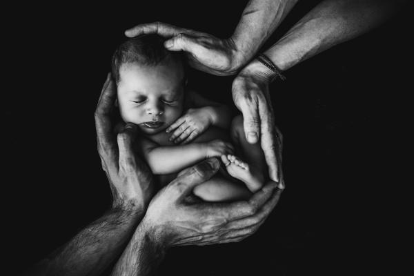 infant in hands