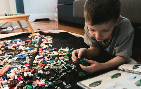 Child playing with Lego