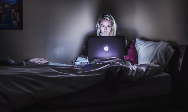 A girl on her laptop at night