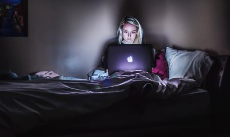 teenage girl using her laptop