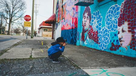 child with graffiti wall